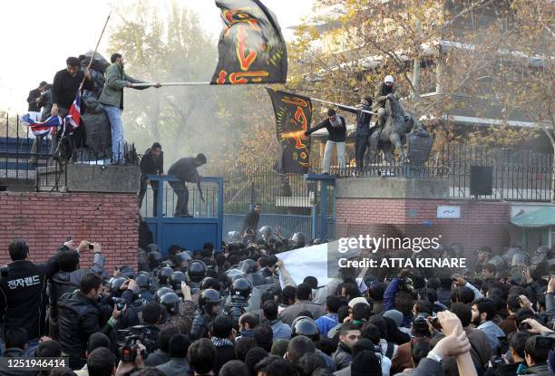 Iranian protesters gather outside the British embassy as some break into it and bring down the British flag in Tehran on November 29, 2011. More than...