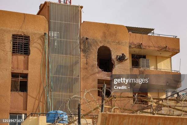 Hole from an explosion is left on the side of a building in Khartoum on April 18, 2023 in the aftermath of fighting between the Sudanese army and...