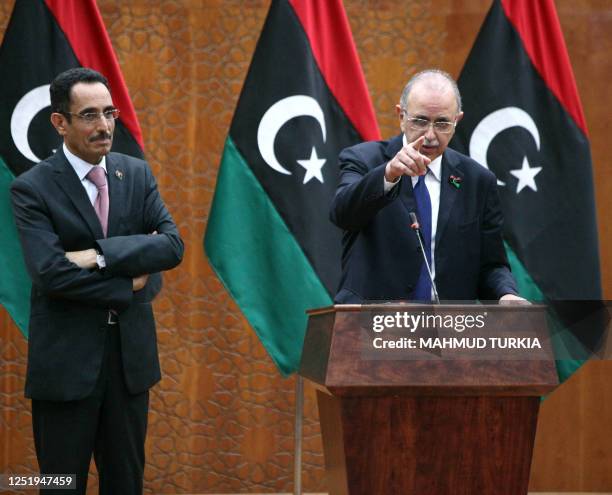 Abdel Hafiz Ghoga , vice chairman of the National Transitional Council and spokesman for the new authorities, stands next to Libya's interim prime...