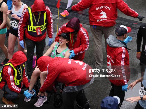 Boston, MA A runner is helped into a wheelchair after finishing the 127th Boston Marathon.