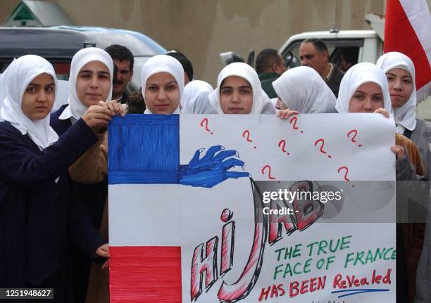 Dozens of members of the League of muslim students of Lebanon protest in front of the French embassy in Beirut against the decision of French...