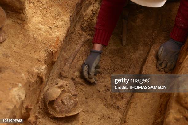 An archaeologist from the Institut National de Recherches Archeologiques Preventives works on an ancient necropolis at Port-Royal metro station in...