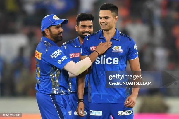 Mumbai Indians' Arjun Tendulkar celebrates with teammates after taking the wicket of Sunrisers Hyderabad's Bhuvneshwar Kumar during the Indian...