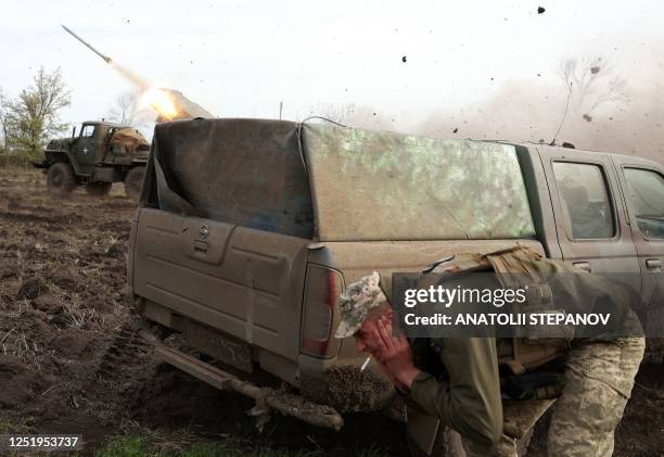 Artillerymen of the Ukrainian 80th separate airborne assault brigade fire from a BM-21 Grad multiple rocket launcher towards Russian positions on the...