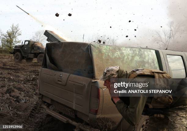 Artillerymen of the Ukrainian 80th separate airborne assault brigade fire from a BM-21 Grad multiple rocket launcher towards Russian positions on the...