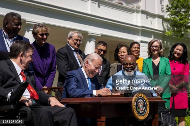President Joe Biden signs an executive order related to childcare and eldercare during an event in the Rose Garden of the White House April 18, 2023...