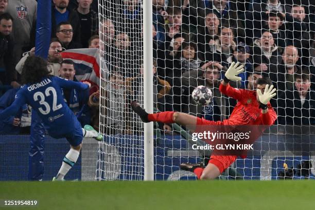 Real Madrid's Belgian goalkeeper Thibaut Courtois savers a shot from Chelsea's Spanish defender Marc Cucurella during the Champions League...