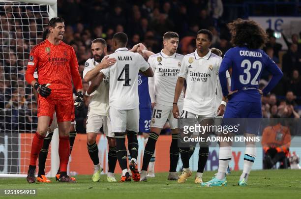 Real Madrid's Belgian goalkeeper Thibaut Courtois reacts after wsaving a shot from Chelsea's Spanish defender Marc Cucurella during the Champions...