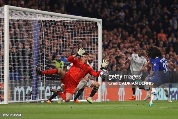 Real Madrid's Belgian goalkeeper Thibaut Courtois savers a shot from Chelsea's Spanish defender Marc Cucurella during the Champions League...