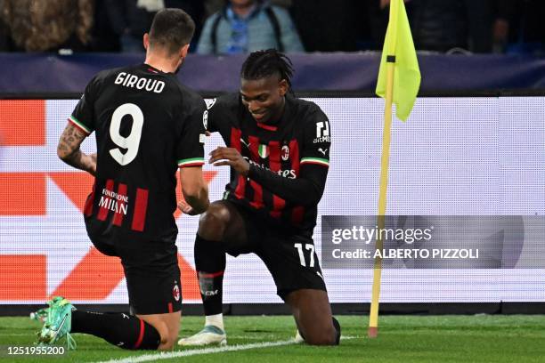 Milan's French forward Olivier Giroud celebrates with AC Milan's Portuguese forward Rafael Leao after opening the scoring during the UEFA Champions...