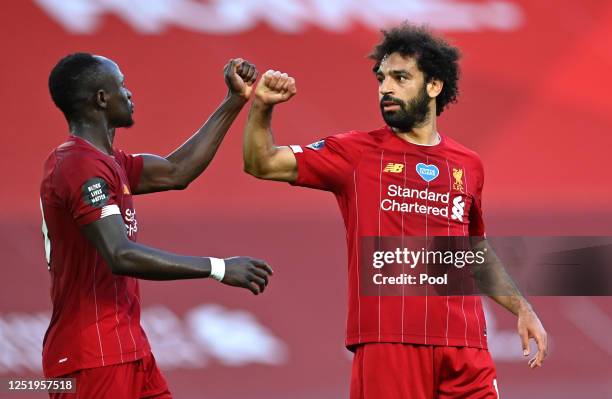 Mohamed Salah of Liverpool celebrates after he scores his sides second goal with Sadio Mane of Liverpool during the Premier League match between...