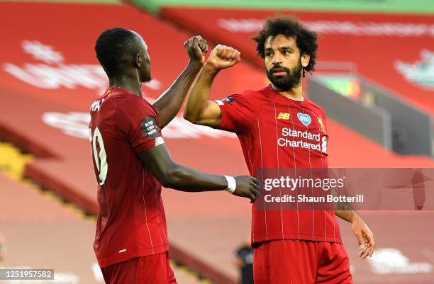 Mohamed Salah of Liverpool celebrates with Sadio Mane of Liverpool after scoring his sides second goal during the Premier League match between...