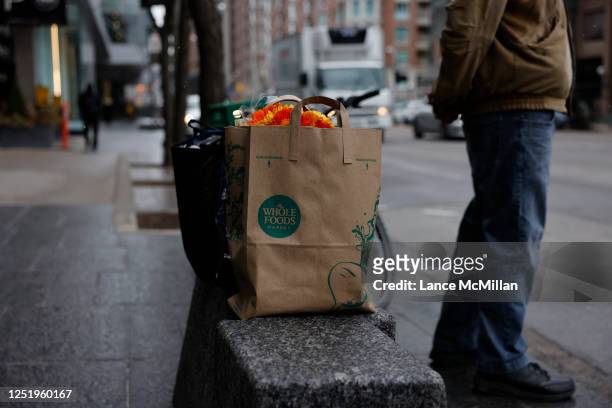 April 18 - A shopper waits for a taxi outside a Whole Foods grocery store near Avenue Rd. And Bloor St. W. In Toronto. Lance McMillan/Toronto Star...