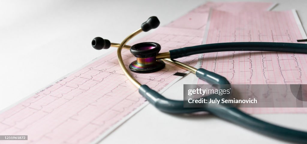 Stethoscope placed on a long electrocardiogram tape