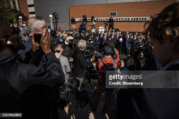 John Poulos, chief executive officer of Dominion Voting Systems, center, speaks during a news conference outside Delaware Superior Court in...