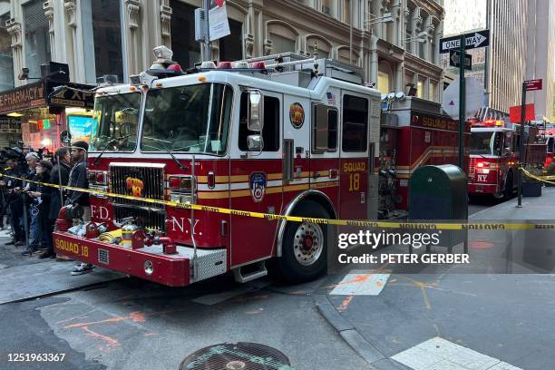 Fire engines of the Fire Department of New York are seen at the scene of a parking garage that collapsed in lower Manhattan, New York City, on April...