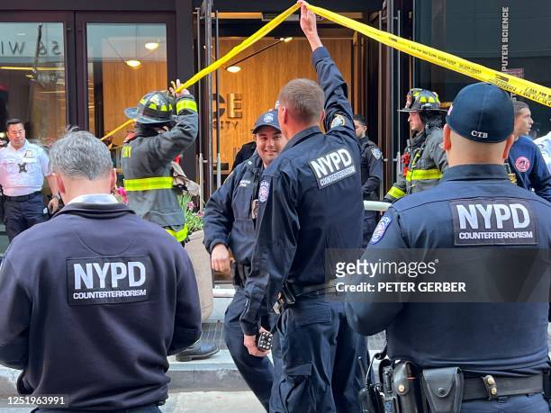 New York Police Department Counter Terrorism officers are seen at the scene of a parking garage that collapsed in lower Manhattan, New York City, on...