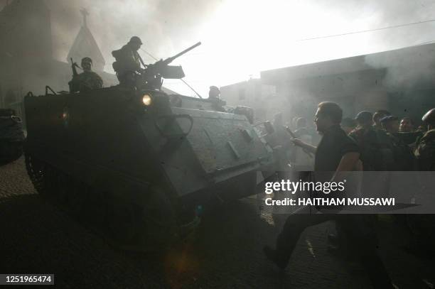 Lebanese troops disperse a demonstration by Christians in the village of Kahaleh, in the mountains east of Beirut, where angry men burnt tyres 05...