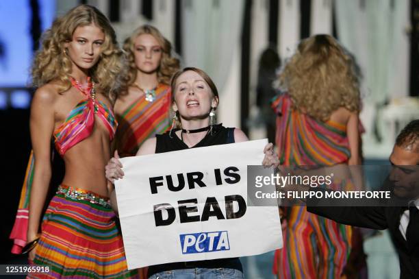 Activist holds a banner 'Fur is dead' during Roberto Cavalli's Spring/Summer 2006 women's collections, 30 September 2005 in Milan.