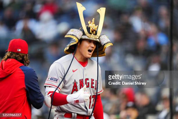 Shohei Ohtani of the Los Angeles Angels wears the Angels' new home run hat, a custom Samurai Kabuto helmet, after hitting a two-run home run in the...