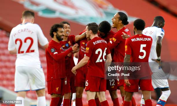 Fabinho of Liverpool celebrates with his team after scoring his sides third goal during the Premier League match between Liverpool FC and Crystal...