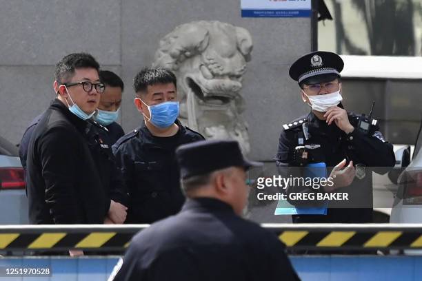 Police officers are seen at the Changfeng Hospital in Beijing on April 19 after a fire broke out a day earlier. - An investigation was underway on...