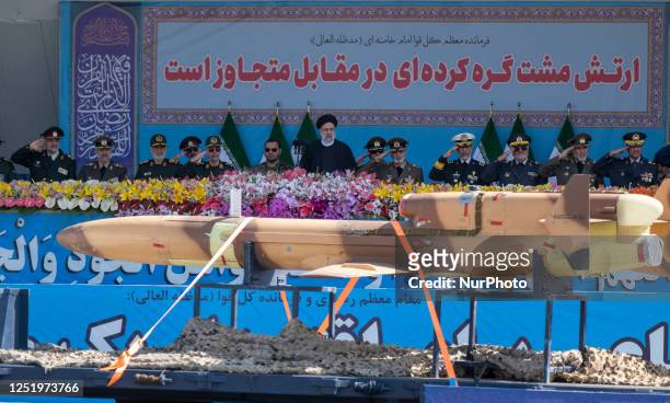 Iranian President Ebrahim Raisi looks at an Iranian-made military drone during a parade marking Iran's Army Day anniversary near the Imam Khomeini...
