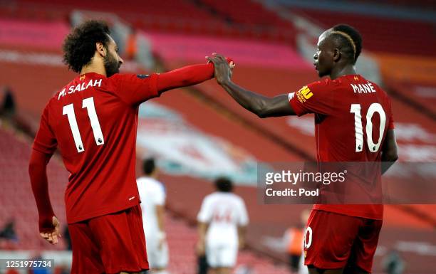 Sadio Mane of Liverpool celebrates with Mohamed Salah of Liverpool after scoring his sides fourth goal during the Premier League match between...