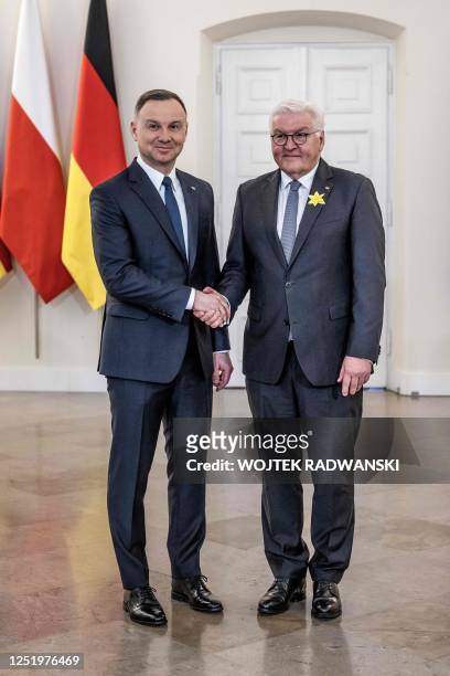 Polish President Andrzej Duda and German President Frank-Walter Steinmeier shake hands at the Presidential Palace in Warsaw, Poland, on April 19...