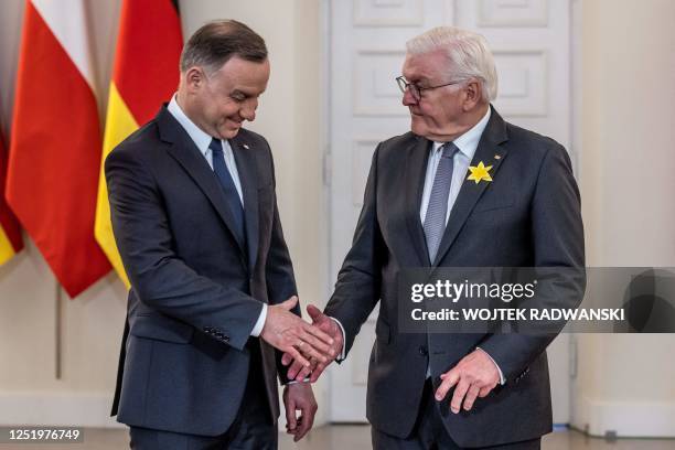 Polish President Andrzej Duda and German President Frank-Walter Steinmeier shake hands at the Presidential Palace in Warsaw, Poland, on April 19...