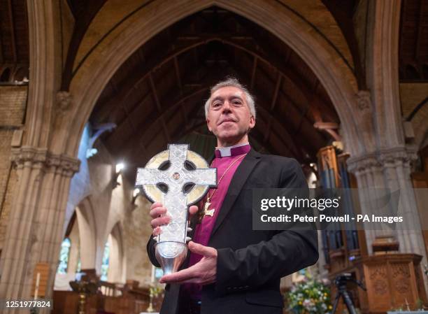 Archbishop of Wales Andrew John with The Cross of Wales ahead of a blessing service at Holy Trinity Church in Llandudno, north Wales. The new...