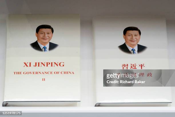 English and Chinese language copies of Chinese President Xi Jinping's 'The Governance of China' is displayed on the 'China International Publishing...