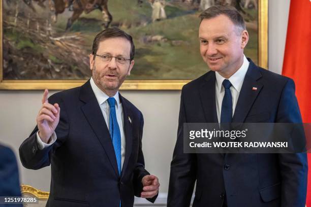 Polish President Andrzej Duda and Israeli President Isaac Herzog pose for pictures during their meeting at the Presidential Palace in Warsaw, Poland,...