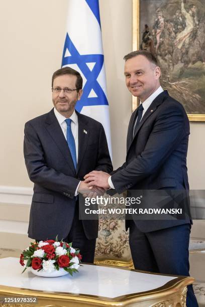 Polish President Andrzej Duda and Israeli President Isaac Herzog shake hands at the Presidential Palace in Warsaw, Poland, on April 19 before the...