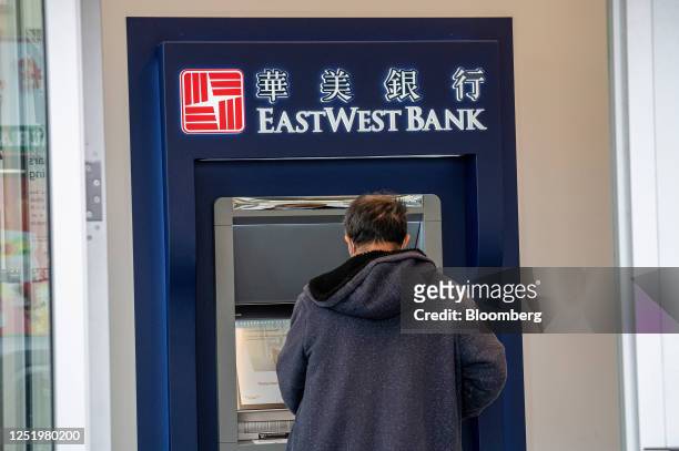 Customer uses a automated teller machine inside an East West Bank branch in San Francisco, California, US, on Friday, April 7, 2023. East West...