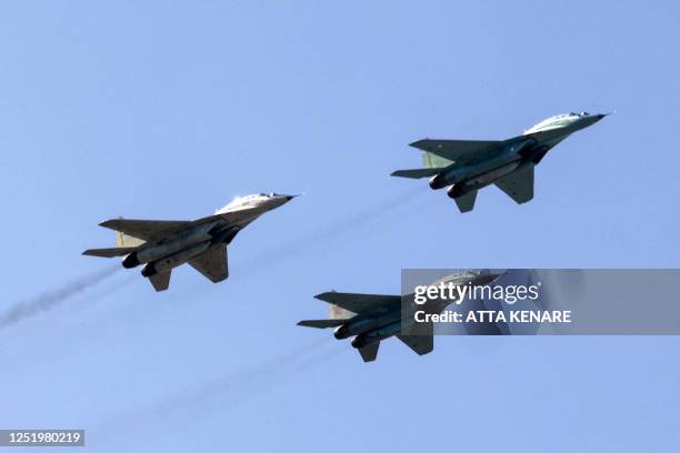 Iranian Air Force MiG-29 jets fly overhead during a ceremony marking the country's annual army day in Tehran on April 18, 2023.