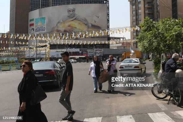 Women walk along a street in Tehran on April 19, 2023. - Iranian police said on April 16 authorities had closed more than 150 businesses in 24 hours...