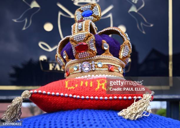 Photograph taken on April 19, 2023 shows a knitted crown on a post office box next to the entrance of the Royal Liverpool Golf club, in Wirral.