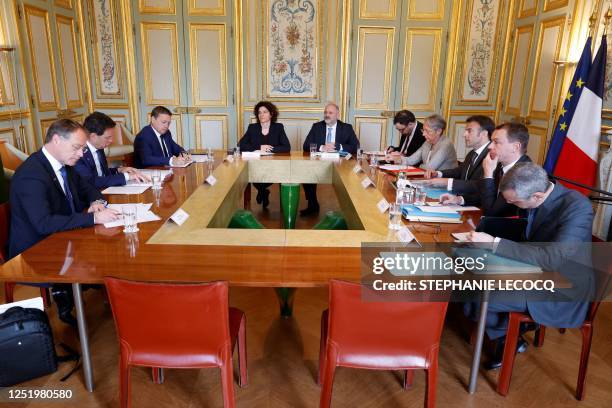 French President Emmanuel Macron , French Prime Minister Elisabeth Borne and French Labour Minister Olivier Dussopt attend the meeting with the...