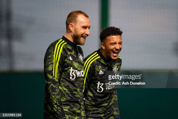 Christian Eriksen & Jadon Sancho of Manchester United reacts during a first team training session at Carrington Training Ground ahead of their UEFA...