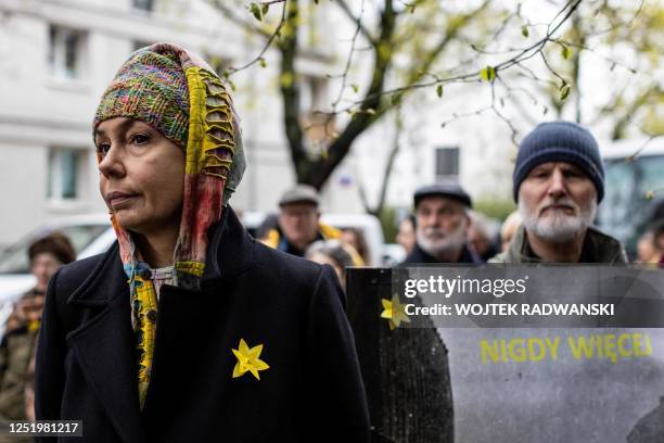 Participants display daffodils as they take part in unofficial ceremonies to mark the 80th anniversary of the start of the Warsaw Jewish Ghetto...