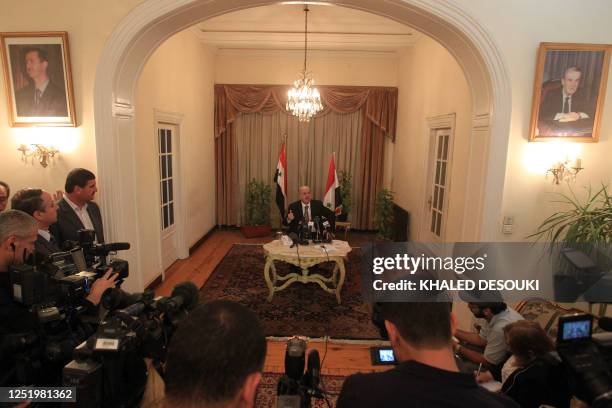Pictures of Syrian late president Hafez al-Assad and his son president Bashar al-Assad are seen in the Syria's embassy as Yussef al-Ahmad, Damascus'...
