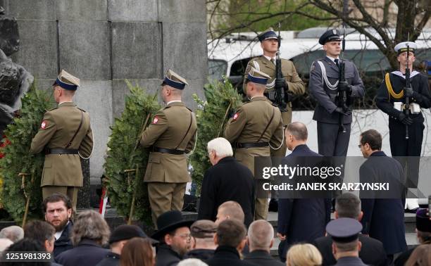 German President Frank-Walter Steinmeier , Polish President Andrzej Duda , and Israel's President Isaac Herzog pay their respects after laying...