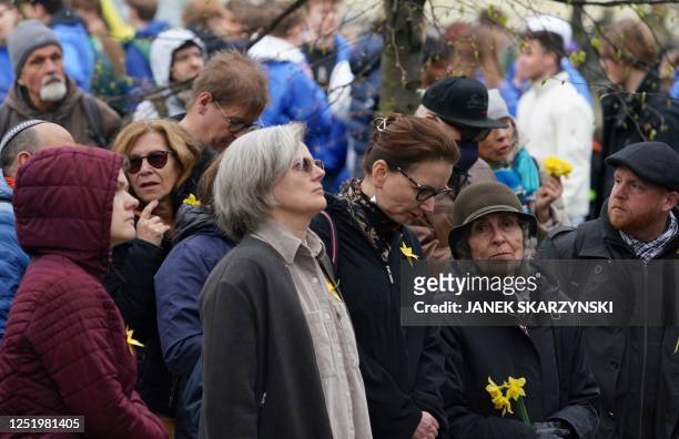 Participants hold daffodils to mark the 80th anniversary of the start of the Warsaw Jewish Ghetto Uprising during commemorations in Warsaw, Poland on...