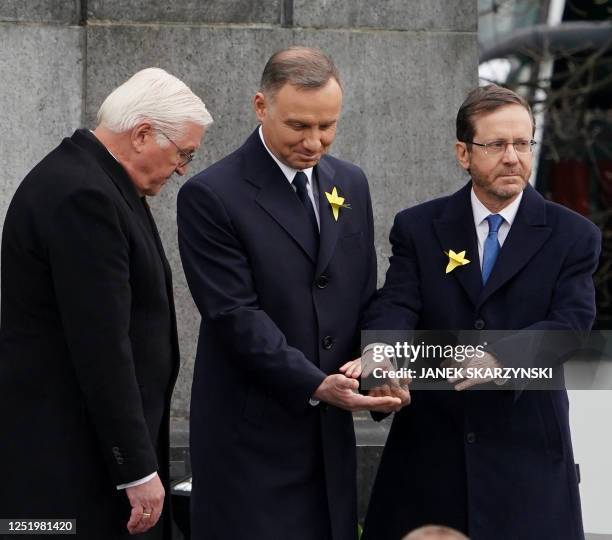 German President Frank-Walter Steinmeier , Polish President Andrzej Duda , and Israel's President Isaac Herzog stand together after laying wreaths at...