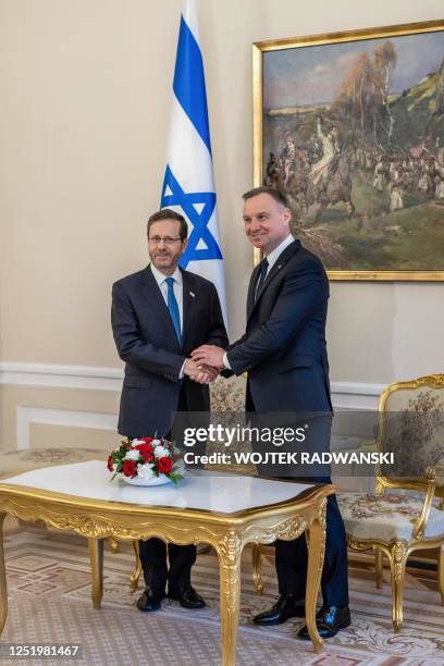 Polish President Andrzej Duda and Israeli President Isaac Herzog shake hands at the Presidential Palace in Warsaw, Poland, on April 19 before the...