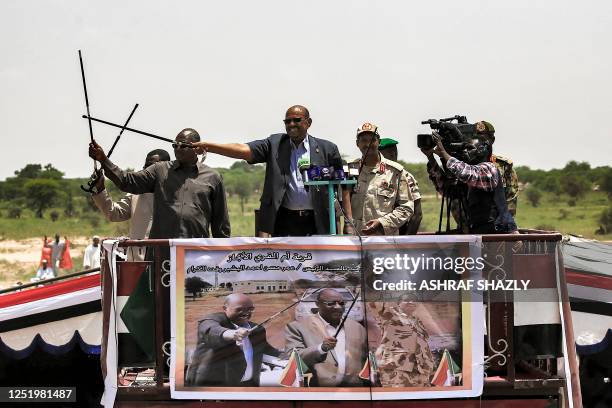 In this picture taken on September 23 Sudanese President Omar al-Bashir waves a walking stick as he gives a speech at the headquarters of the Rapid...