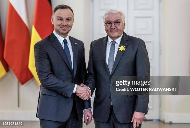 Polish President Andrzej Duda and German President Frank-Walter Steinmeier shake hands at the Presidential Palace in Warsaw, Poland, on April 19...