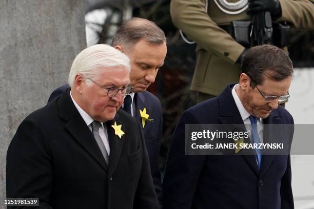 German President Frank-Walter Steinmeier , Polish President Andrzej Duda , and Israel's President Isaac Herzog leave after laying wreaths at The...