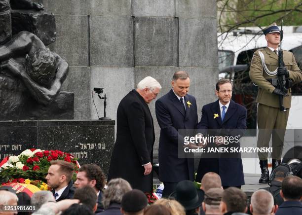German President Frank-Walter Steinmeier , Polish President Andrzej Duda , and Israel's President Isaac Herzog stand together after laying wreaths at...
